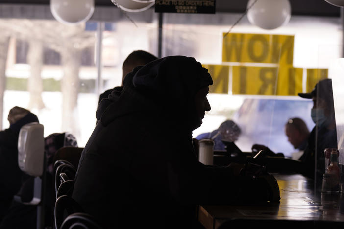 Patrons sit in a restaurant without power caused by cold weather blackouts on Tuesday in Richardson, Texas.