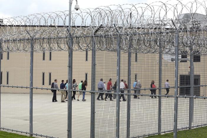 People walk on a tour of the State Correctional Institution at Phoenix in Collegeville, Pa., in 2018. Two brothers who were at the facility have been freed by clemency after expecting to spend their lives incarcerated.