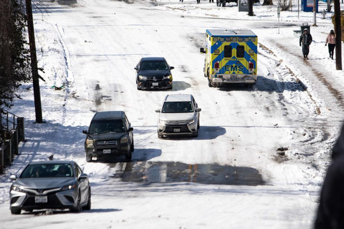 An ambulance drives on Oltorf Street in the Travis Heights neighborhood of South Austin on Tuesday.