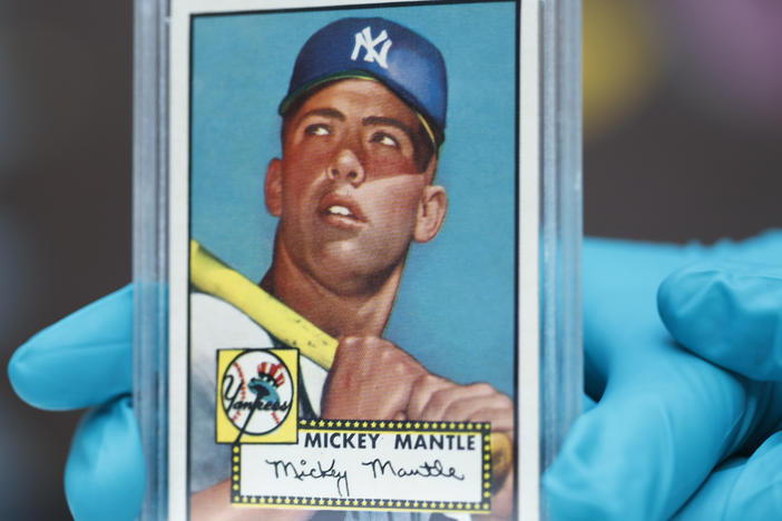 The "Holy Grail" of baseball cards, a 1952 Topps Mickey Mantle, is put on display as part of a baseball memorabilia exhibit at the History Colorado Center on July 16, 2018, in Denver.