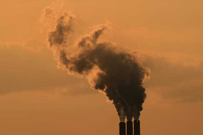 Smokestacks at the Jeffrey Energy Center coal-fired power plant are silhouetted against the sky at sunset in September near Emmet, Kan.