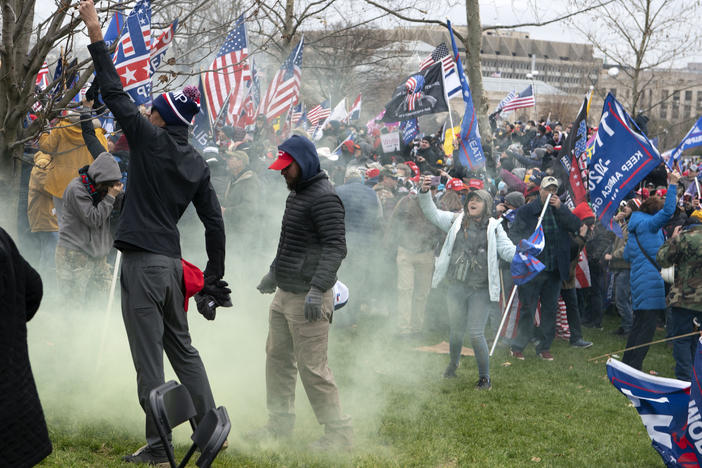 Supporters of former President Donald Trump protest as U.S. Capitol Police officers shoot tear gas during the assault on the Capitol Jan. 6.