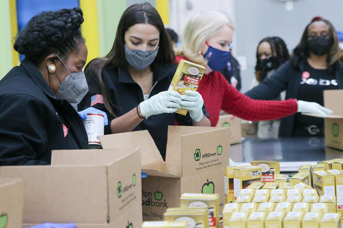 Reps. Sheila Jackson Lee (from left), Alexandria Ocasio-Cortez and Sylvia Garcia help distribute food at the Houston Food Bank on Saturday.