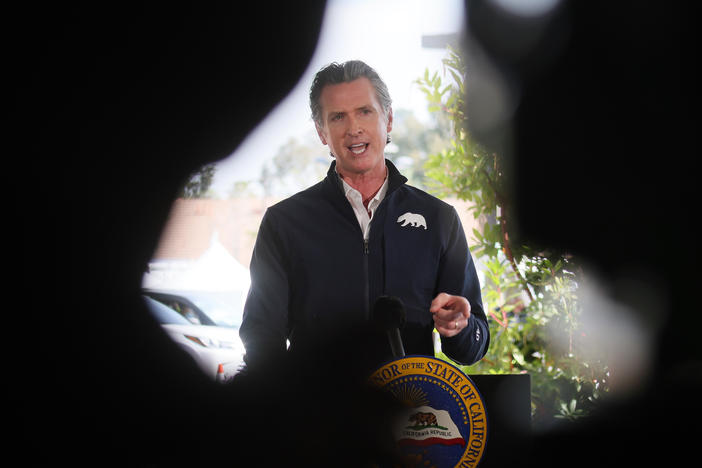 California Governor Gavin Newsom speaks at a press conference following the opening of a new large scale COVID-19 vaccination site in Los Angeles on Tuesday. Newsom says the state will start setting aside 10% of its vaccine allotment for teachers, day care workers and other school employees.