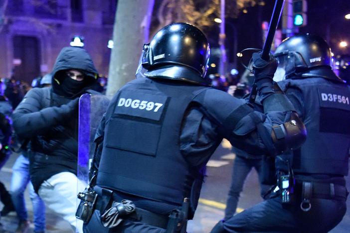 Protesters clash with Mossos d'Esquadra, the Catalan police force, following a demonstration Saturday in Barcelona against the imprisonment of Spanish rapper Pablo Hasel.