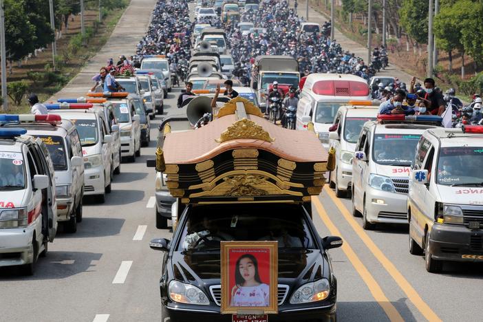 A car carrying the body of protester Mya Thwet Thwet Khine is pictured at the head of a convoy during her funeral service Sunday in Naypyitaw. She was the first confirmed fatality in the ongoing protests against the military coup.
