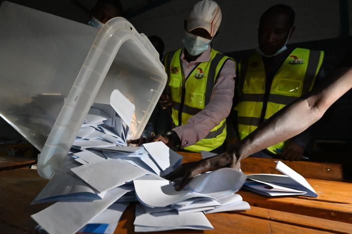 Niger's Electoral Commission workers count the ballots at a polling station during Niger's presidential election runoff in Niamey on Sunday. In the country's west, a vehicle carrying poll workers struck a landmine, killing seven and seriously wounding three others. It's unclear if the vehicle was deliberately attacked.