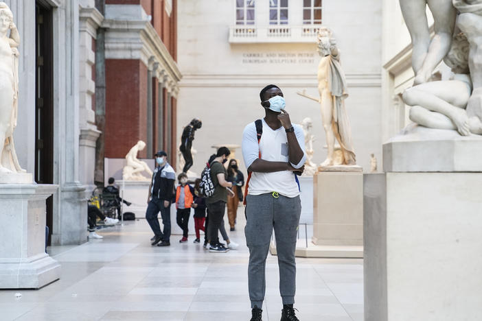 Visitors wear masks at the Metropolitan Museum of Art in October. The museum's director says the Met is considering selling art to pay for operating expenses.