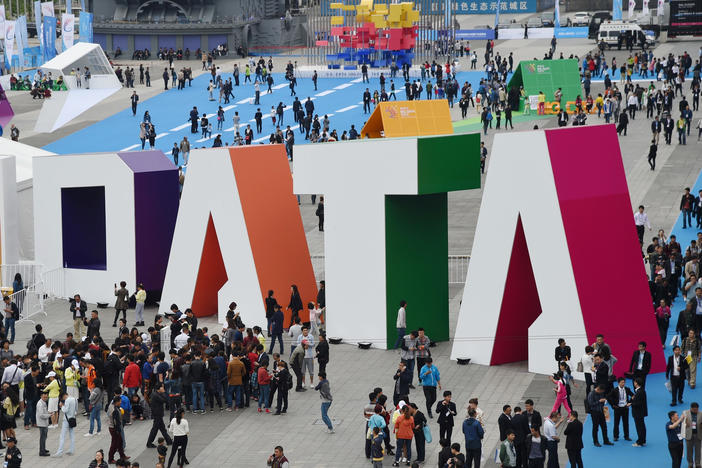 Visitors walk past the giant word "Data" during the Guiyang International Big Data Expo 2016 in southwestern China. China says it's determined to be a leader in using artificial intelligence to sort through big data. U.S. officials say the Chinese efforts include the collection of hundreds of millions of records on U.S. citizens. The photo was released by China's Xinhua News Agency.