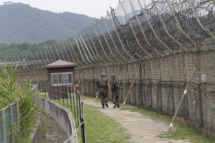 South Korean soldiers patrol while hikers visit the DMZ Peace Trail in the Demilitarized Zone in Goseong, South Korea. A defector from North Korea was apprehended in Goseong last week after evading South Korean guards for hours.
