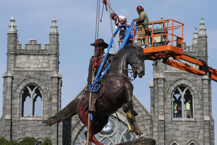 Crews attach straps in July to the statue of Confederate Gen. J.E.B. Stuart in Richmond, Va. The statue was one of several that were removed by the city in 2020 following nationwide protests against systemic racism.