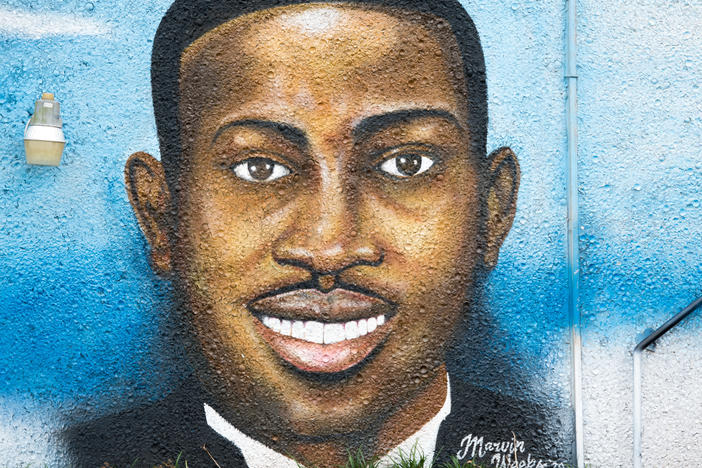 A mural depicting Ahmaud Arbery in July 2020 in Brunswick, Ga. Gregory McMichael, Travis McMichael and William "Roddie" Bryan are facing murder charges in connection with his death.