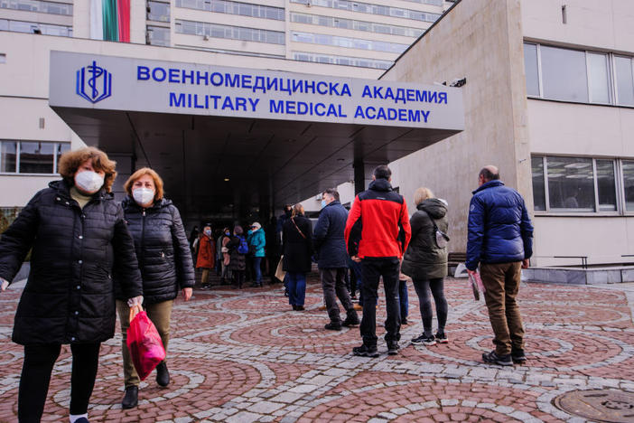 People wait in front of the hospital of the Military Medical Academy in Sofia, Bulgaria, on Feb. 21 for a COVID-19 vaccination.