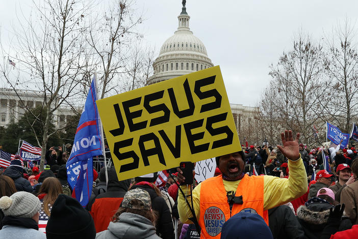 Protesters gather outside the U.S. Capitol on Jan. 6 in Washington, D.C., some with signs and symbols of Christianity. Pro-Trump protesters entered the U.S. Capitol that day after mass demonstrations in the nation's capital.