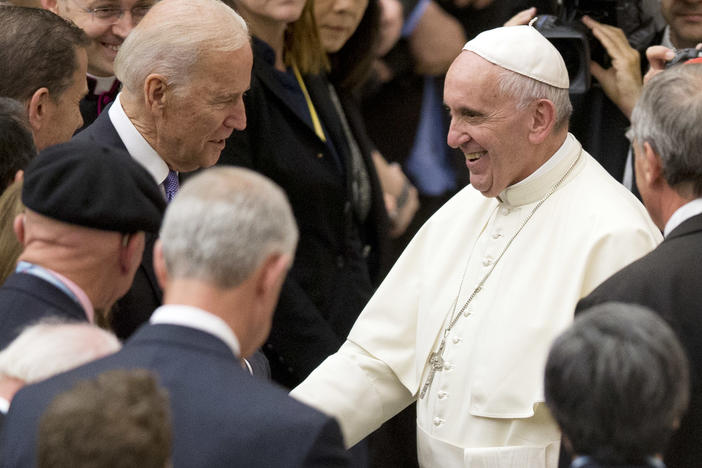 Pope Francis shakes hands with Joe Biden, then vice president, at the Vatican, in 2016.