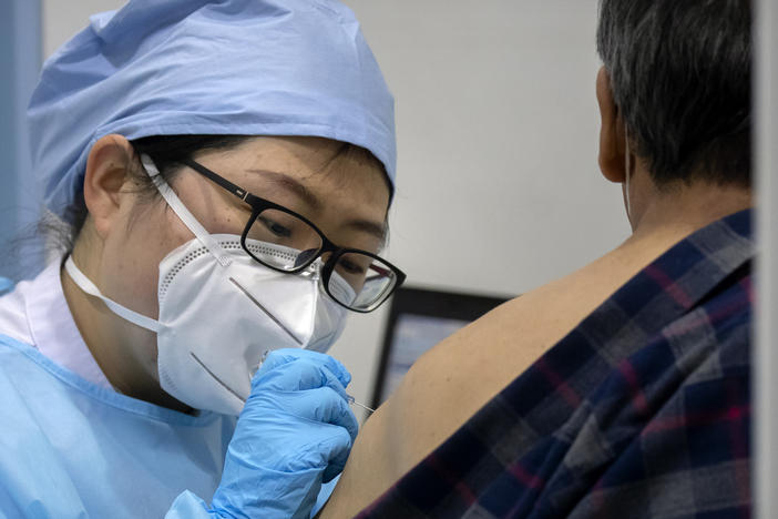A medical worker gives a coronavirus vaccine shot to a patient at a vaccination facility in Beijing, in January. Two pharmaceutical companies in China announced Wednesday they are seeking market approval for new vaccines.