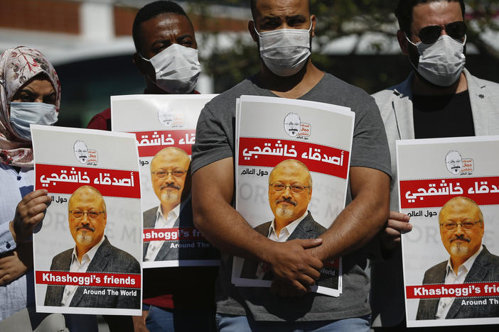 People hold posters of slain Saudi journalist Jamal Khashoggi, near Saudi Arabia's consulate in Istanbul in the fall, marking the two-year anniversary of his death.