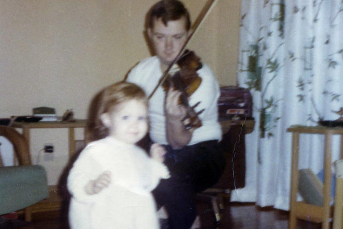 A young Jack Ranney, of Champaign, Ill., plays the violin for his daughter, Jillian. Jack died Nov. 23, 2020, at the age of 80 from COVID-19.