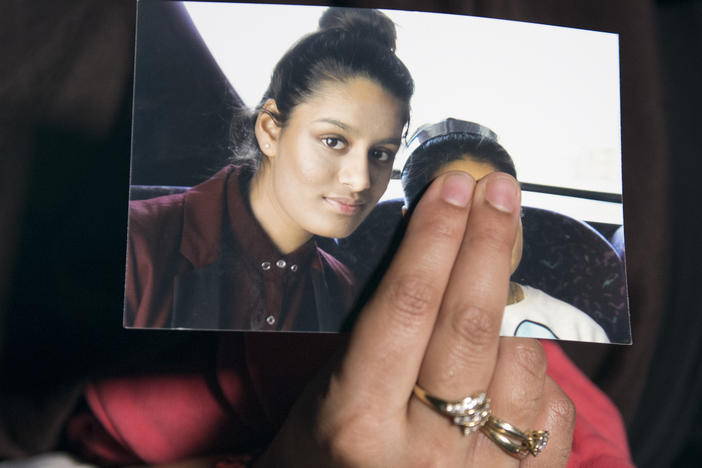 Renu Begum, eldest sister of Shamima Begum, holds her sister's photo as she is interviewed by the media at New Scotland Yard. The U.K. revoked Shamima Begum's British citizenship two years ago, citing security concerns.