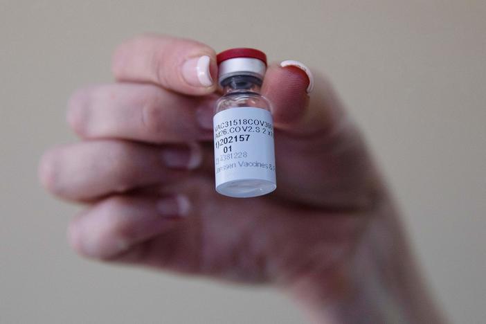 A health care worker holds a vial of the Johnson & Johnson COVID-19 vaccine at Klerksdorp Hospital in Klerksdorp, South Africa, on Feb. 18.