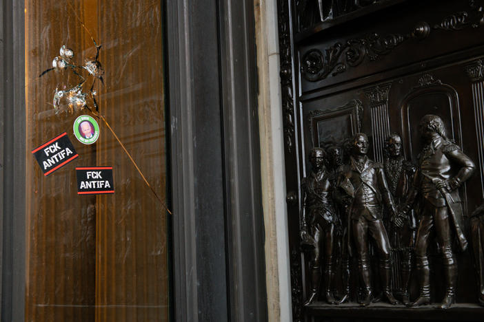 Stickers reading "Fck Antifa" are stuck on a broken window at the U.S. Capitol after the building was breached by rioters on Jan. 6.