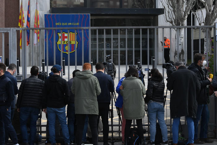 Journalists line the front gate of FC Barcelona offices on Monday during a police operation inside.