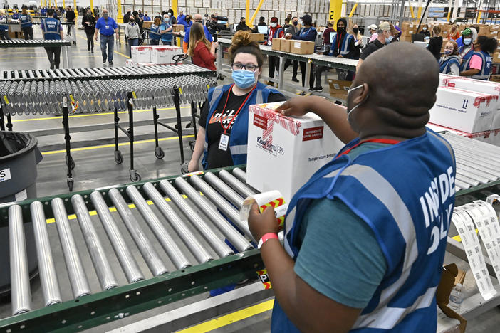 The first box of Johnson & Johnson's COVID-19 vaccine departs from a facility in Shepherdsville, Ky., on Monday. The company is set to distribute its first 3.9 million doses across the U.S. this week.