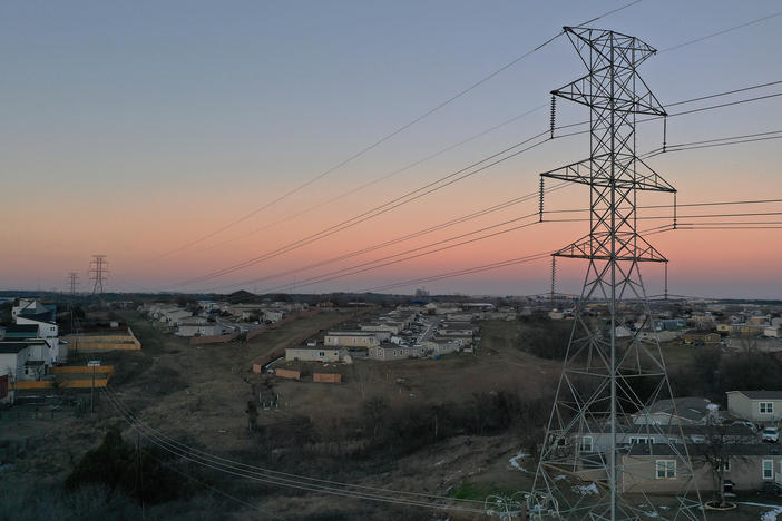 "As Texans struggled to survive this winter storm, Griddy made the suffering even worse as it debited outrageous amounts each day," Texas Attorney General Ken Paxton said as his office sued the company. Here, electrical lines run through a neighborhood in Austin during the recent winter storms.