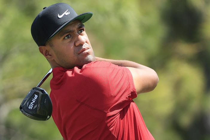 Tony Finau and other top golfers wore red in a tribute to Tiger Woods on Sunday, wishing him a full recovery from a dangerous car crash.