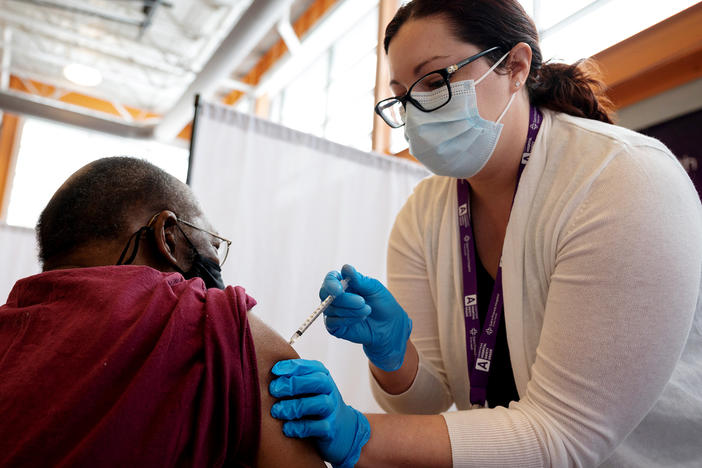 Trinity Health RN Kayla Bennett gives Hartford, Conn., resident James Watts his first dose of the COVID-19 vaccine at a neighborhood vaccine clinic at the at the Parker Memorial Community Center.