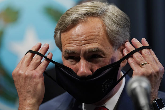 Texas Gov. Greg Abbott, seen here donning a mask in September, announced Tuesday he will lift the state's mask mandate.