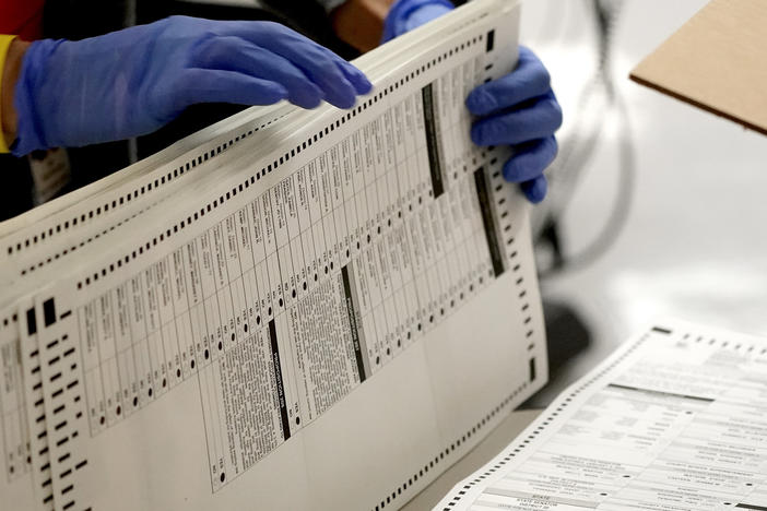 Eight years after carving the heart out of a landmark voting rights law, the Supreme Court heard arguments in a case that could put new limits on efforts to combat racial discrimination in voting.