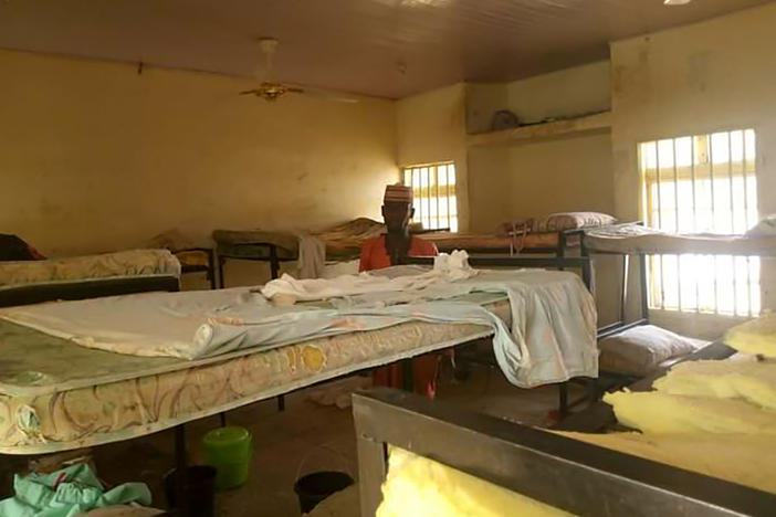 A man stands in the deserted school dormitory after gunmen invaded and took away more than 270 girls in Jangebe in northwest Nigeria, on Feb. 26. The girls have all since been returned.