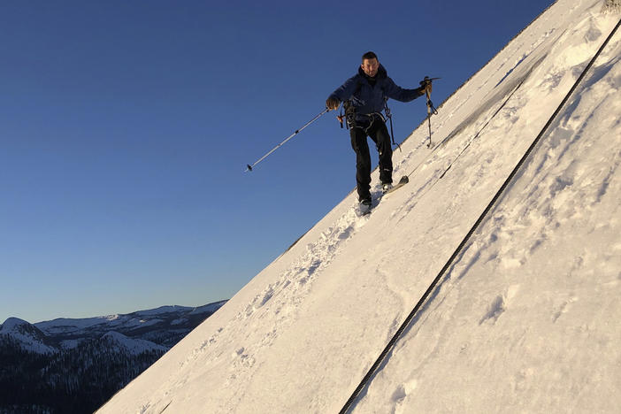 In this photo provided by Jason Torlano, Zach Milligan is shown on his descent down Half Dome in Yosemite National Park, Calif., on Feb. 21. The two men climbed some 4,000 feet to the top of Yosemite's Half Dome in subfreezing temperatures and skied down the famously steep monolith to the valley floor.