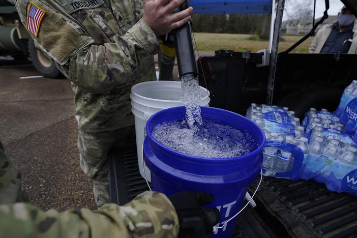 Water for flushing toilets was being distributed at seven sites in Mississippi's capital city — more than 10 days after winter storms wreaked havoc on the city's water system because the system is still struggling to maintain consistent water pressure, authorities said.