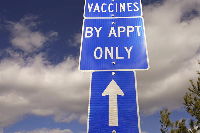 A sign directs motorists to a drive-up COVID-19 vaccine clinic in Exeter, N.H., in February. White House officials announced on Wednesday that a new pilot program will aim to remove common barriers to vaccination for some 2 million seniors from vulnerable communities.