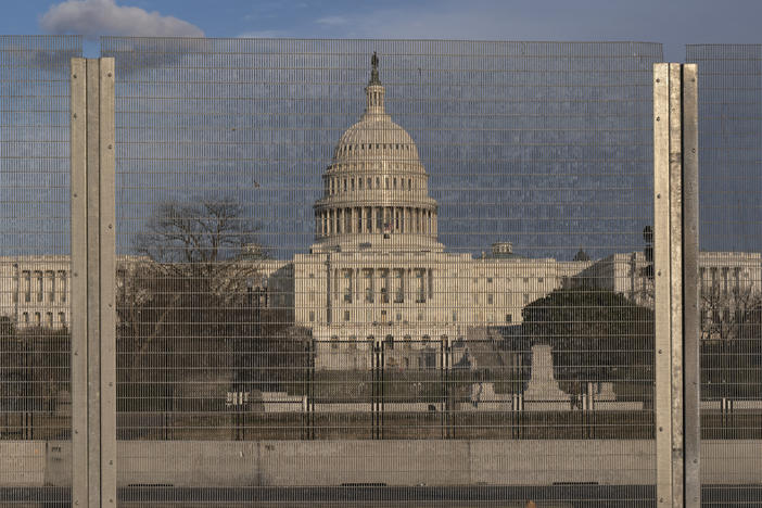 A section of fencing blocks the Capitol grounds at sunset on Monday.