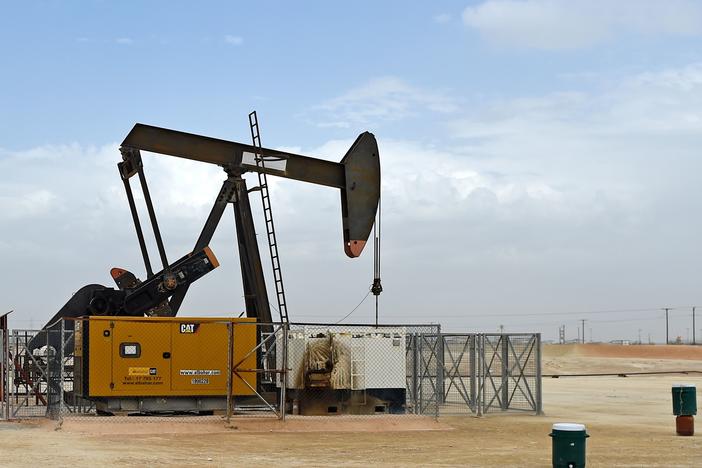 A pumpjack operates in the desert oil fields in southern Bahrain on April 22, 2020. Bahrain and other members of the OPEC+ alliance decided Thursday to keep output largely unchanged as they hope to push crude prices even higher after a recent rally.