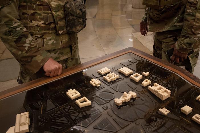 National Guard members examine a terrain model of Capitol Hill on Thursday. U.S. Capitol Police requested the guardsmen stay another two months after threats of further  violence emerged.