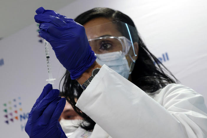 A medical worker at South Shore University Hospital gets ready to administer the newly available Johnson & Johnson COVID-19 vaccine in Bay Shore, N.Y., Wednesday. Clinical research found it to be 85% effective in preventing severe disease four weeks after vaccination, and it has demonstrated promising indications of protection against a couple of concerning variants of the coronavirus.