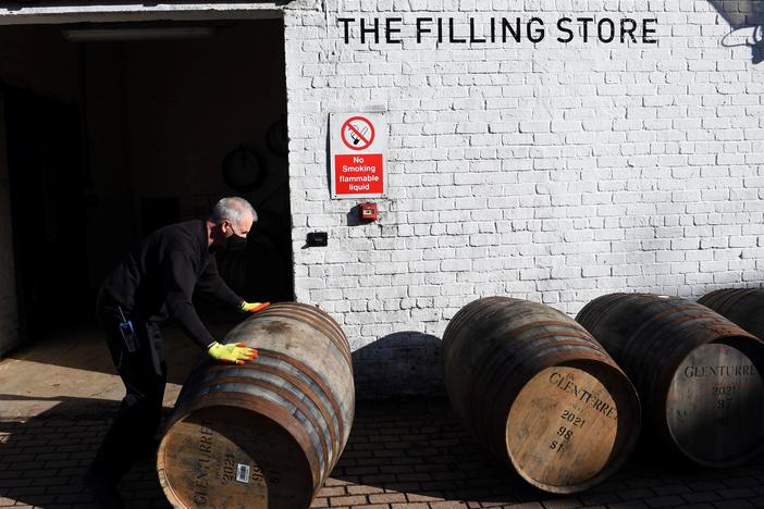 Scotch whisky producers are welcoming news of a breakthrough on tariffs, which came as the industry adjusted to both Brexit and then the COVID-19 pandemic. Here, an employee rolls a whisky barrel at the Glenturret Distillery in Crieff, central Scotland, last week.