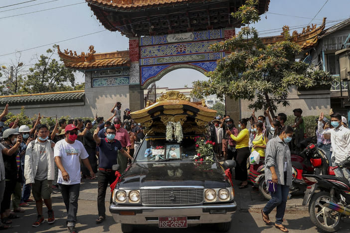 Bystanders flash a three-fingered sign of resistance as the body of Kyal Sin leaves the Yunnan Chinese temple in Mandalay, Myanmar earlier this week.