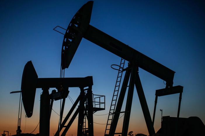 Oil pump jacks operate at dusk in Long Beach, Calif., on April 21, 2020. After getting burned by the oil industry's previous boom-and-bust cycles, Wall Street now wants energy companies to pump less crude, not more.