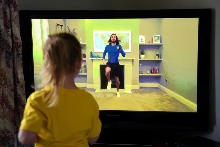 Four-year-old Lois Copley-Jones, the photographer's daughter, takes part in a livestreamed broadcast of "PE With Joe" on March 23, 2020, in Newcastle-under-Lyme, England. The popular fitness series ended Friday.