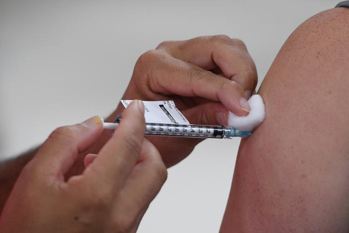 A health care worker in Sydney, Australia receives their COVID-19 vaccination this month. Italian authorities got the European Commission to block a shipment of 250,700 doses of vaccine destined for Australia from Europe this week.