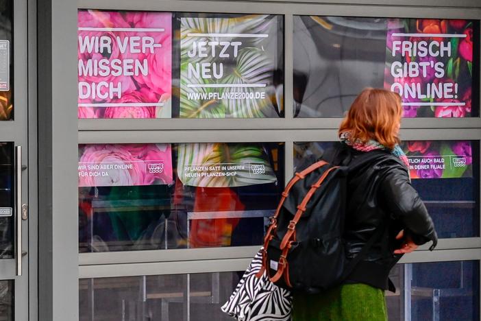 A woman walks past a closed flower shop in Berlin on Thursday. A research group noted more than 1,200 new words in German inspired by the pandemic.