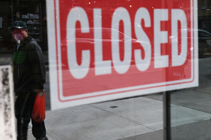 A store in New York City stands closed on April 21, 2020. A year after the coronavirus pandemic was declared, millions of Americans are still unemployed.