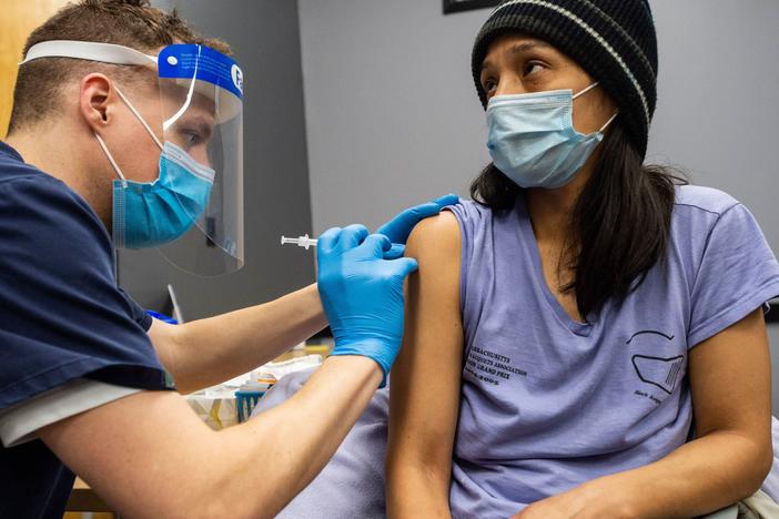 Edith Arangoitia receives a COVID-19 vaccination in Chelsea, Mass., a heavily Hispanic community, on Feb. 16.