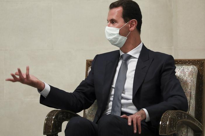 Syrian President Bashar Assad gestures while speaking to Russian Foreign Minister Sergey Lavrov during talks in Damascus in September. Assad and his wife, Asma, have been diagnosed with coronavirus infection, according to an official statement.