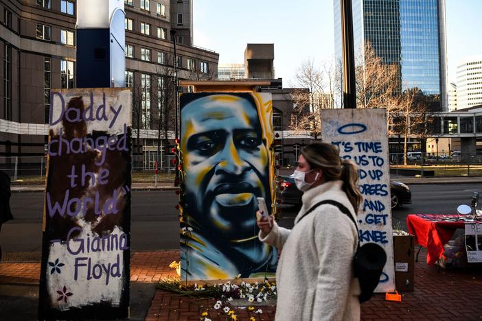 Hennepin County Judge Peter Cahill sent potential jurors in Derek Chauvin's trial home on Monday. Here, a painting of Floyd is seen outside the Hennepin County Government Center, where the trial is taking place.